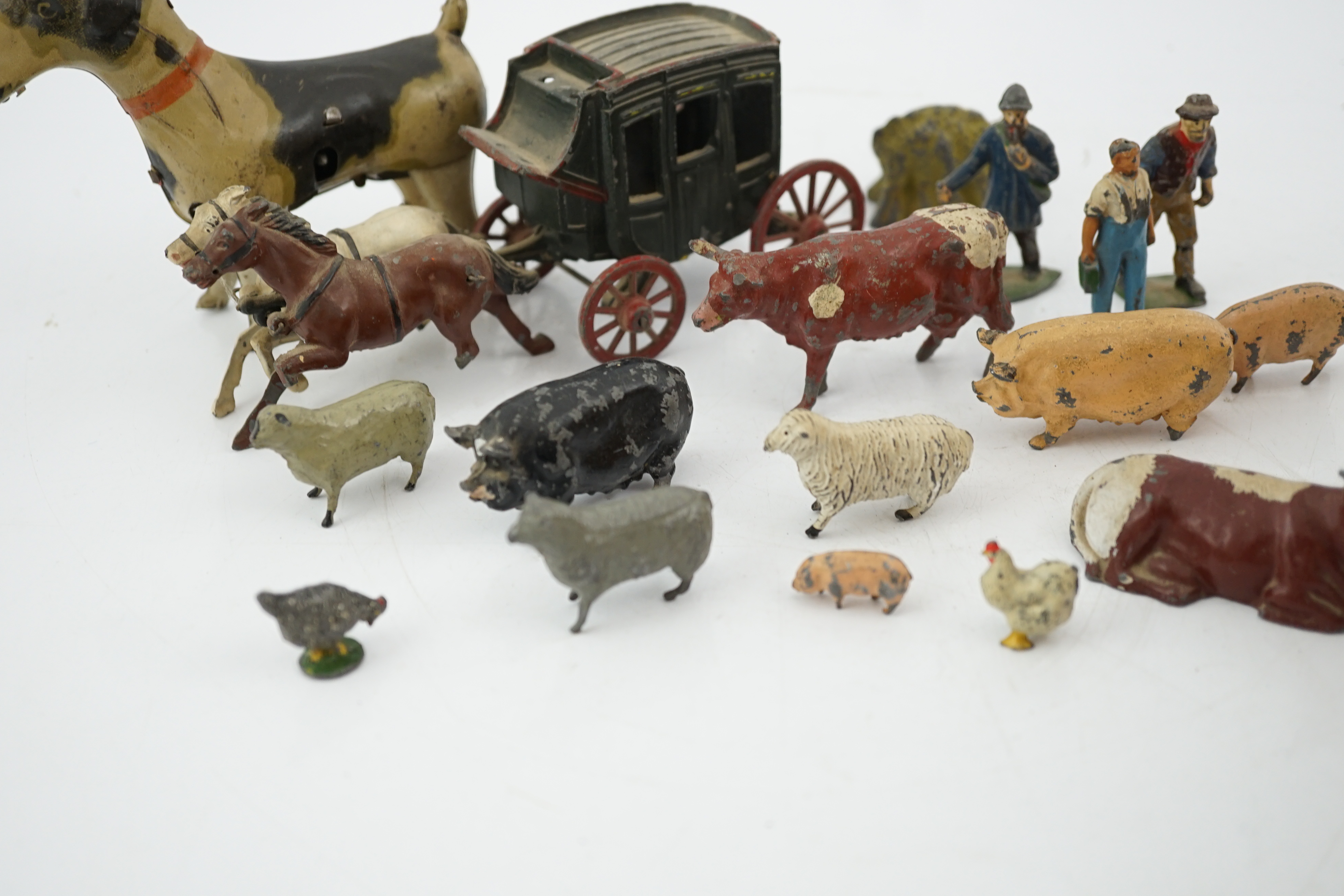 A collection of Britains, etc. lead farm animals and accessories, including the farmer, farmer’s wife, a coach and horses and other figures